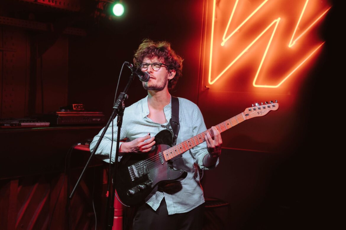 Singer-guitarist performing at an open stage